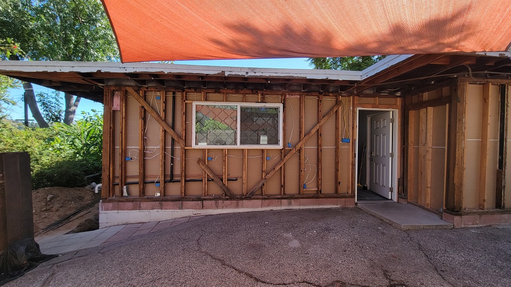 ADU renovation in progress showing exposed framing, open walls, and structural prep work.