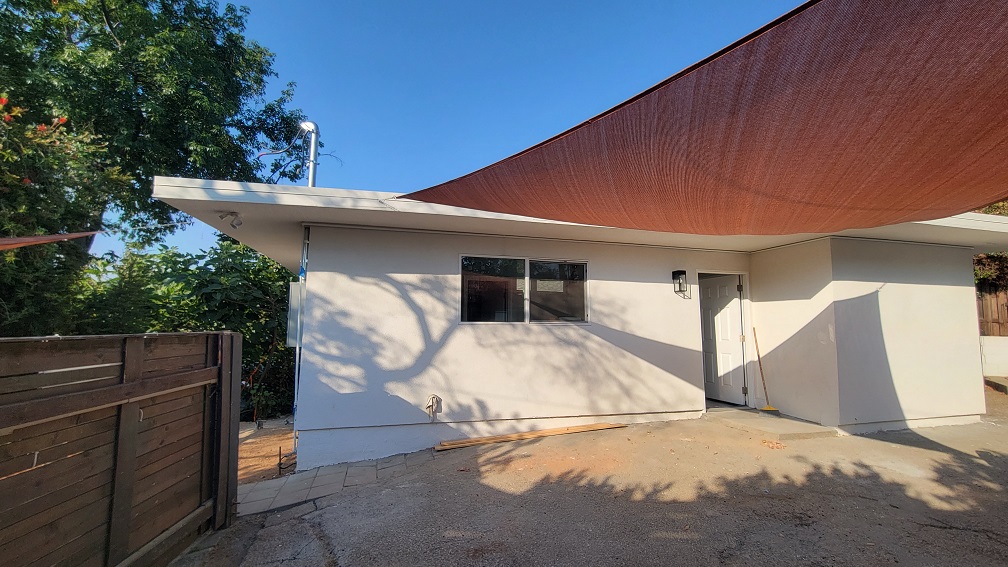 Finalized ADU exterior showing new stucco, updated fascia, and clean outdoor space.