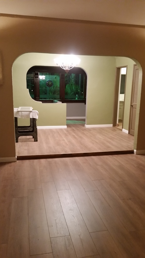 Interior remodel with updated flooring and new open-concept archway.