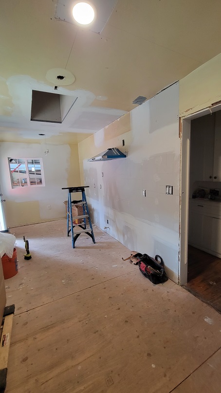 Kitchen remodel in progress with drywall and prep work underway.